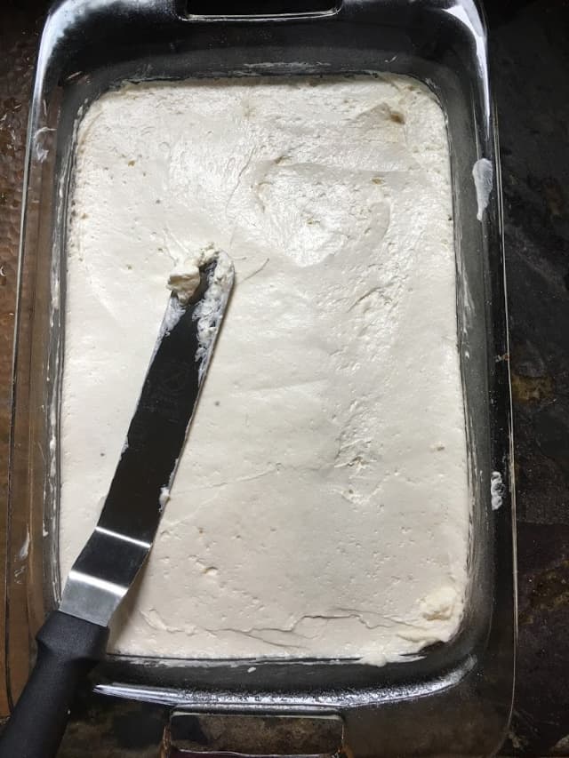 Cool whip mixture spread out smooth on top of the crust in a 9x13 pan