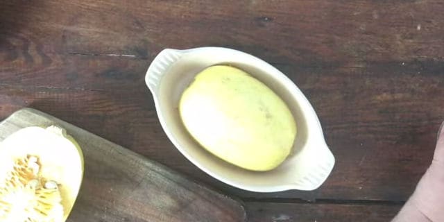 half a spaghetti squash in a small microwave bowl