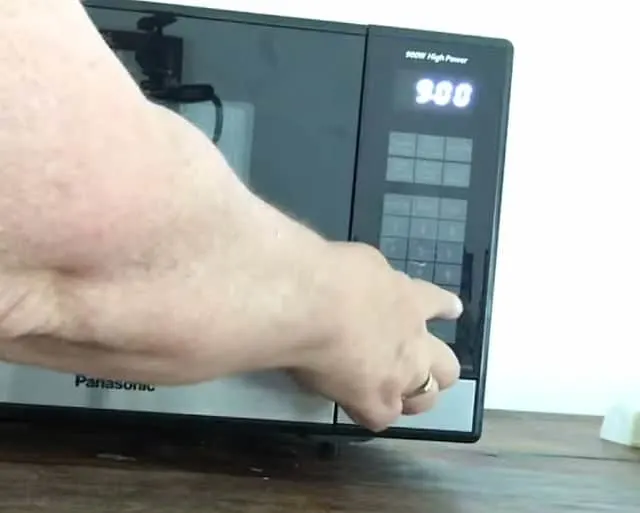 finger entering 9 minutes on a microwave