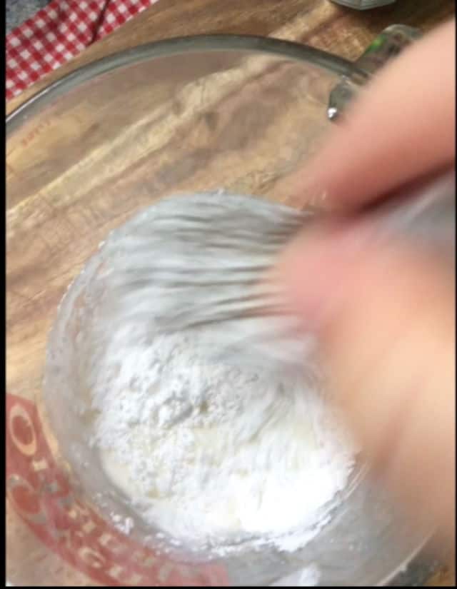 mixing cake glaze ingredients together with a whisk