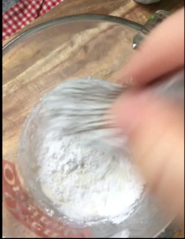 mixing cake glaze ingredients together with a whisk