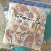 Bag of frozen chicken on a marble background