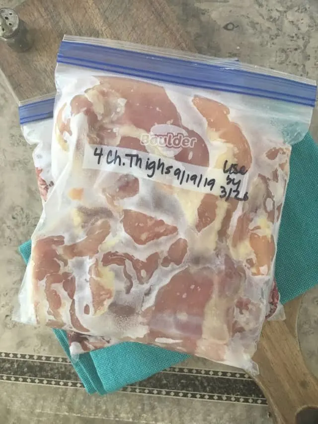 Bag of frozen chicken on a marble background