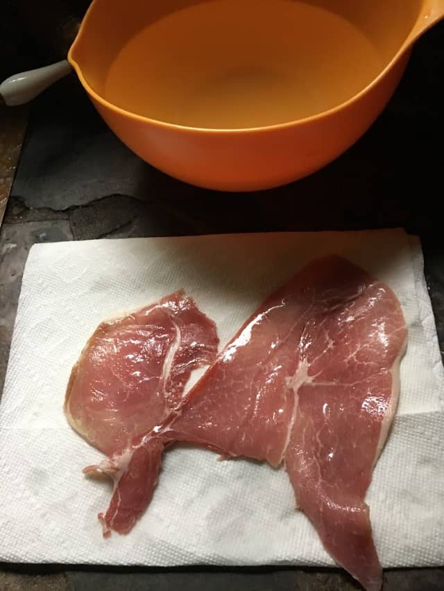 slice of country ham drying on a paper towel