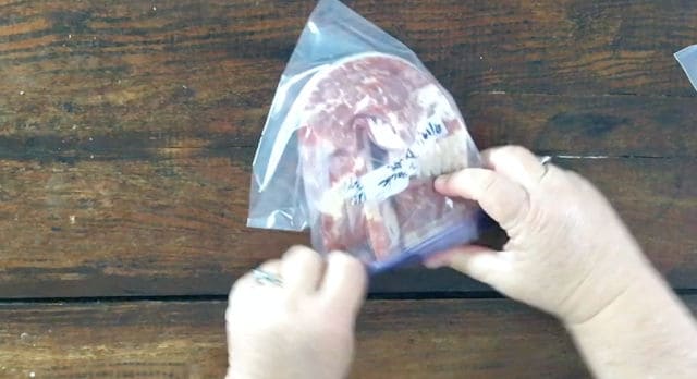 hands putting bacon into bag