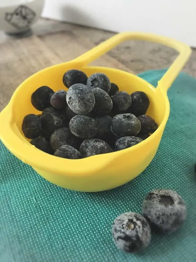 1/2 Cup measure full of frozen blueberries