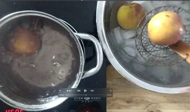 moving peaches from boiling water to ice bath with kitchen spider