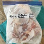 quart size bag of frozen bacon on blue towel