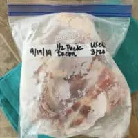 quart size bag of frozen bacon on blue towel