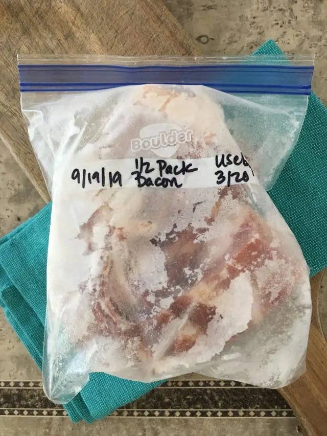 quart size bag of frozen bacon on blue towel