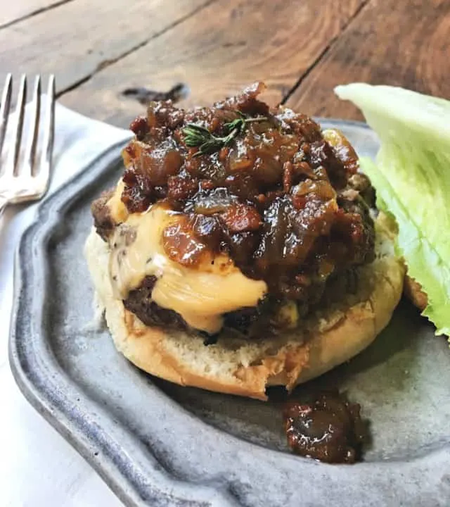 Bacon jam on a cheeseburger on bun on plate