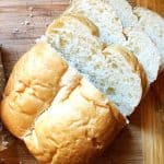 homemade loaf of bread on cutting board with slices