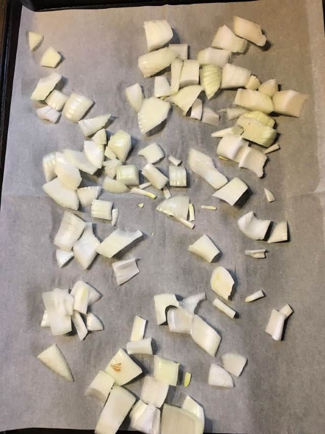diced onion on baking sheet with parchment paper
