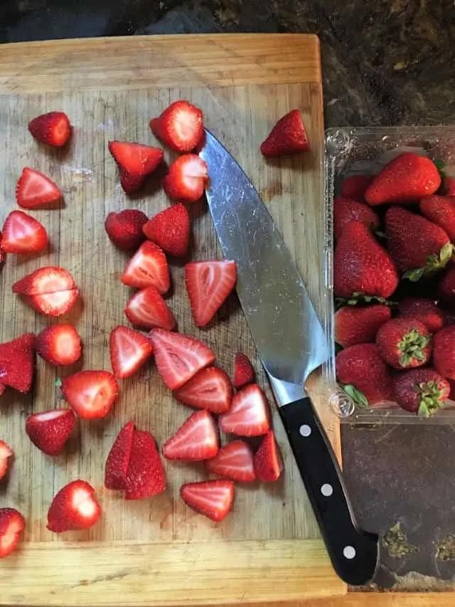 cutting board with knife and strawberries