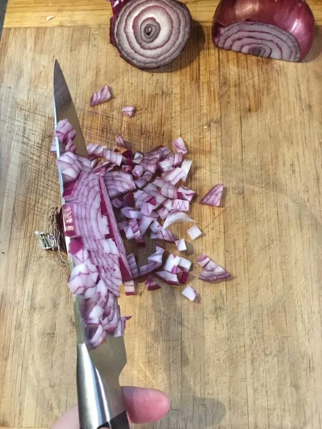 diced purple onion, knife and cutting board