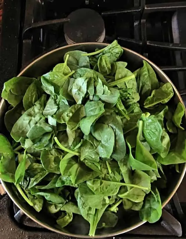 spinach in a frying pan ready to be wilted