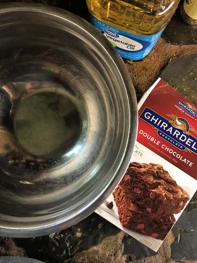 empty silver bowl with box of brownie mix