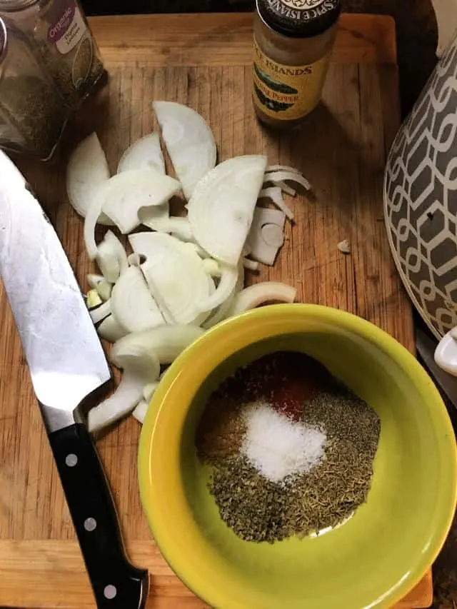 spices in bowl with cut onion in background