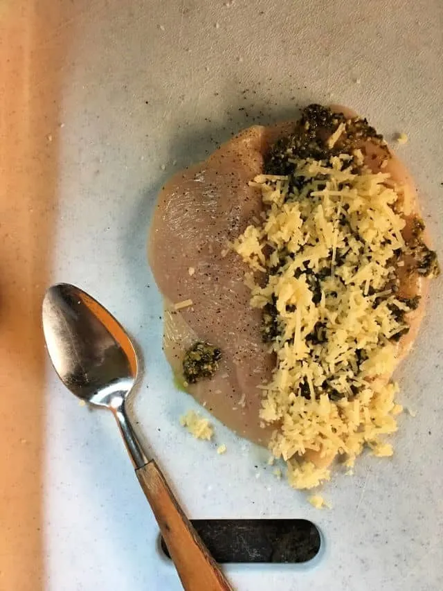 spoon and chicken breast with parmesan and pesto butterfly