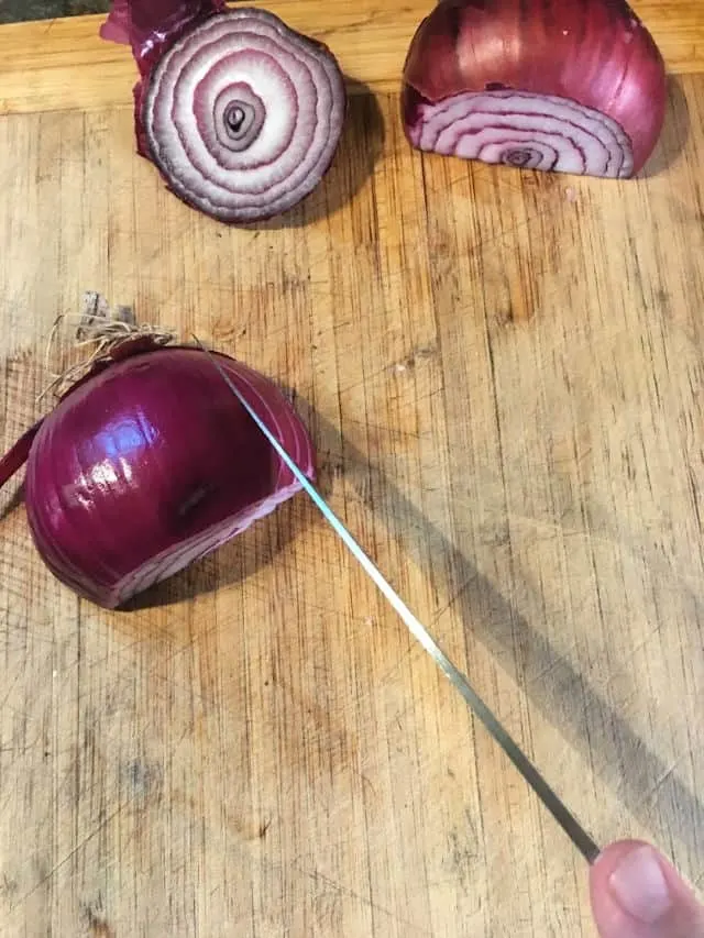 Knife and onion on cutting board