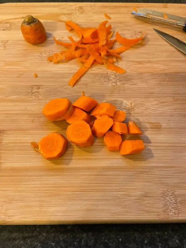 Carrots cut into pieces on cutting board
