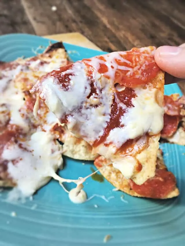 close up of one pizza nachos with pepperoni and cheese