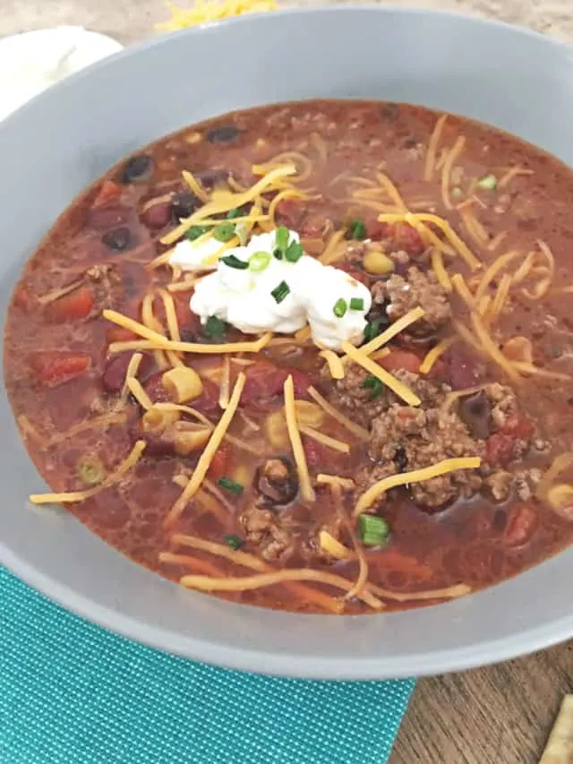 gray bowl with 8 can taco soup, cheese and sour cream