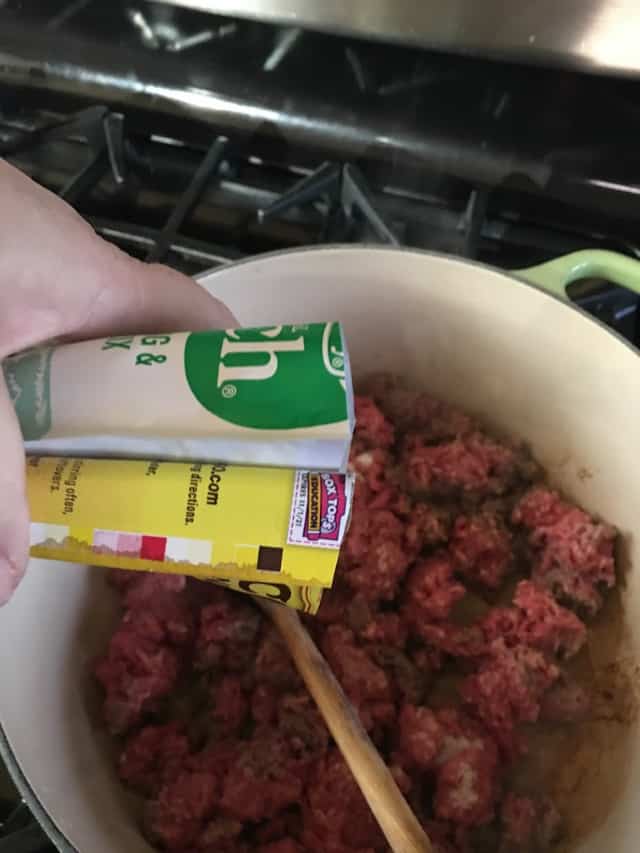 adding seasoning packets to ground beef