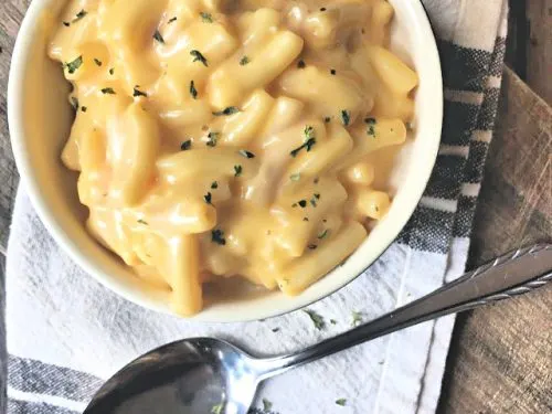 overhead shot of bowl of mac and cheese with spoon