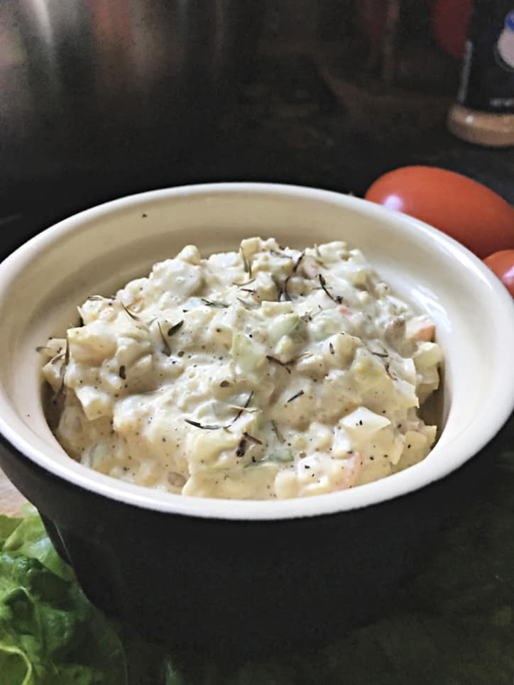 closeup from the side of a black bowl with with interior full of slaw