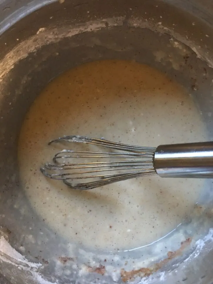 whisk in a metal bowl with batter