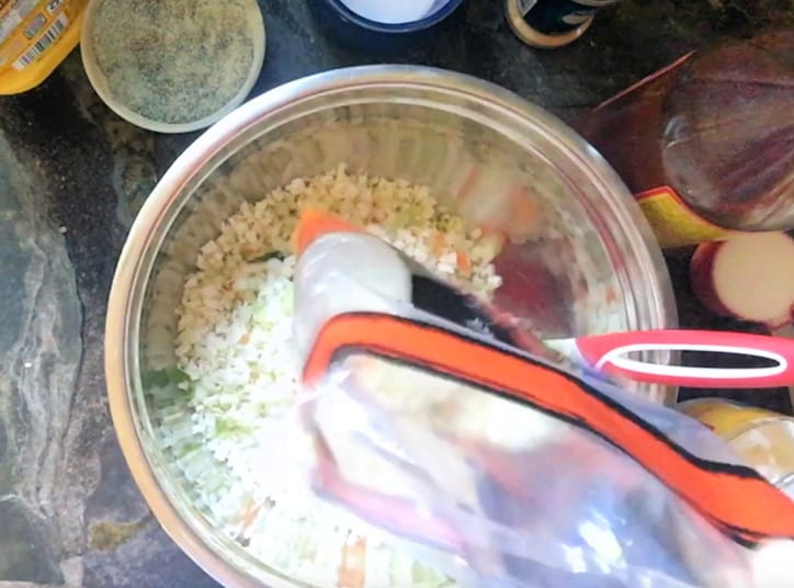 bag of colesalw mix being added to silver bowl