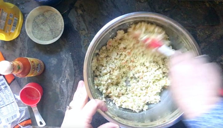 mixing up how to make coleslaw from a bag in silver bowl
