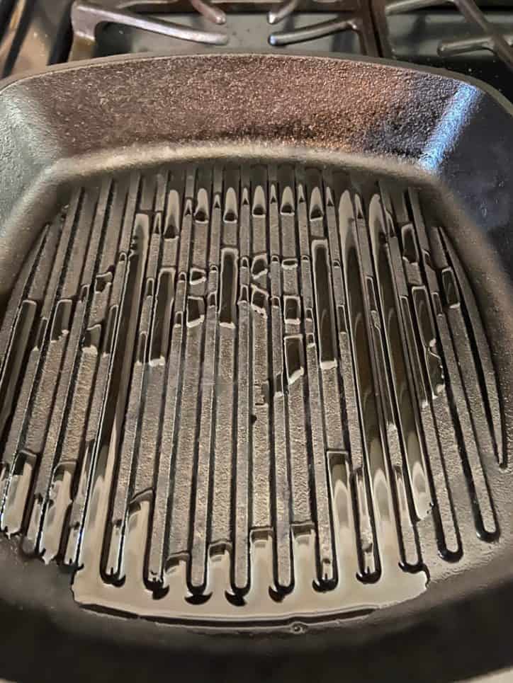 black cast iron grill pan with oil.
