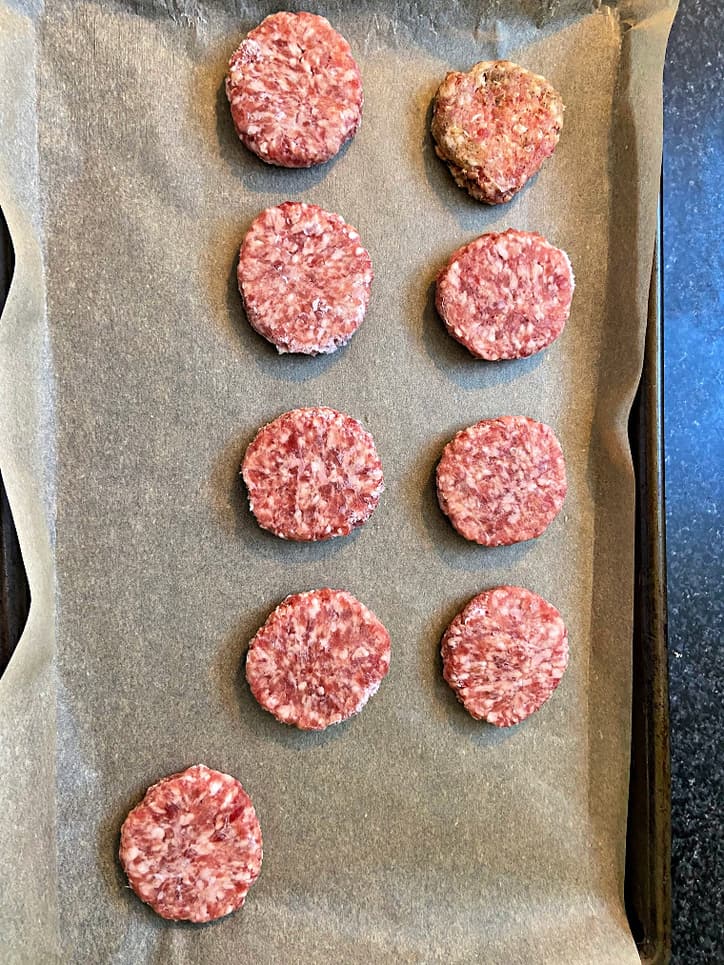 sausage patties on parchment paper ready for oven