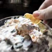 loaded ranch dip on a chip scooped from bowl