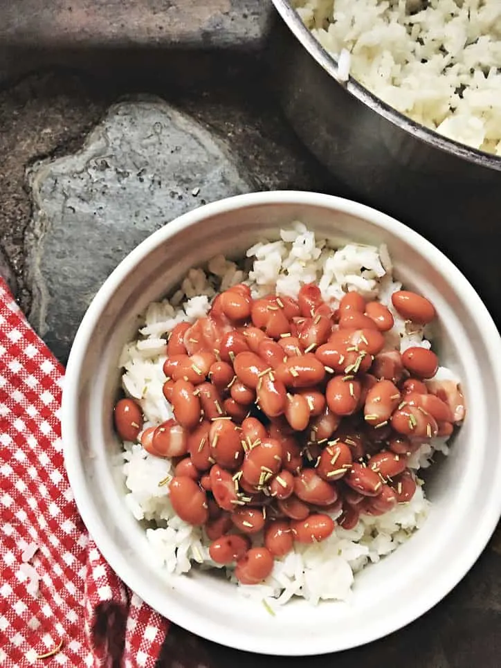 bowl of popeyes red beans and rice with large pot of rice