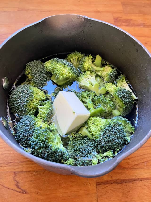 saucepan with water vegetable and butter