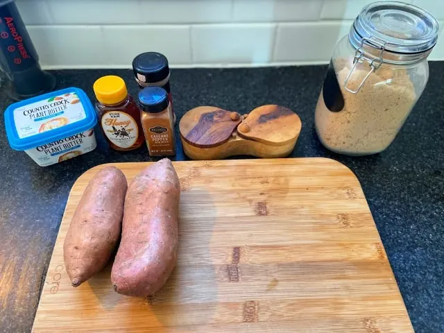 Sweet potatoes and ingredients on cutting board
