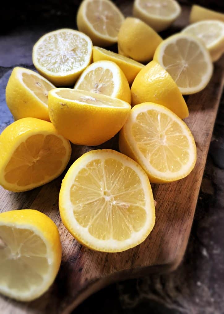 lemons cut in half on wooden cutting board