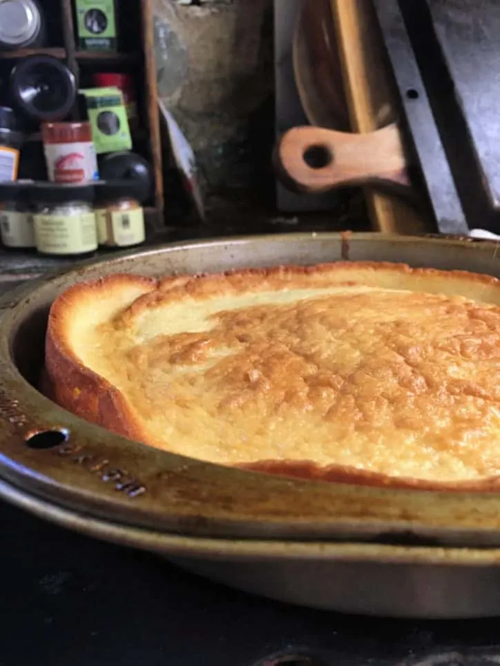 The edge of a rumbled cake in pan with cutting boards