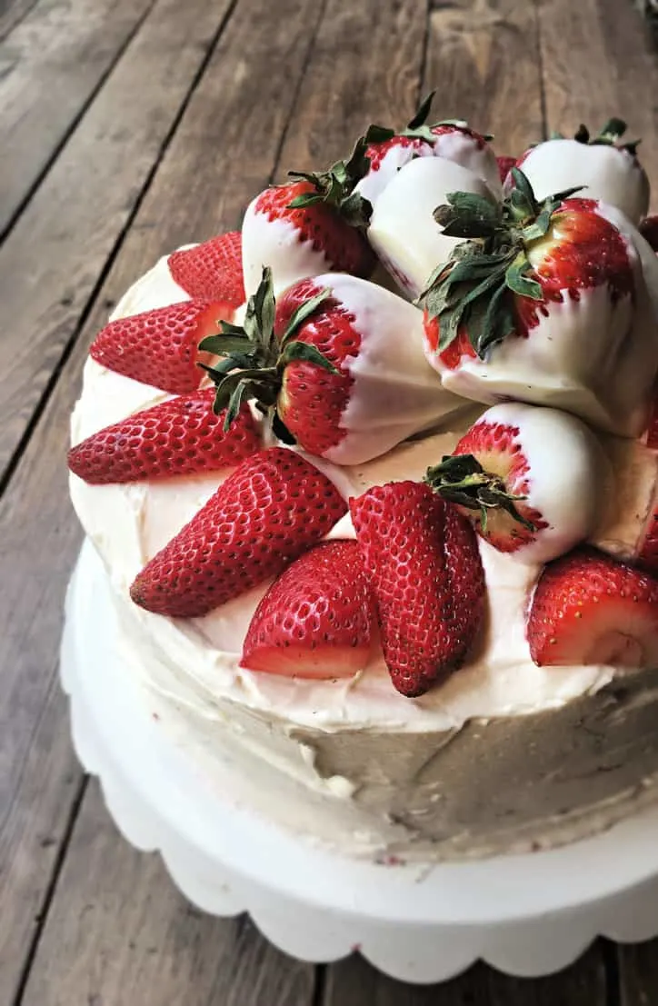 three quarters of cake with strawberries on cake