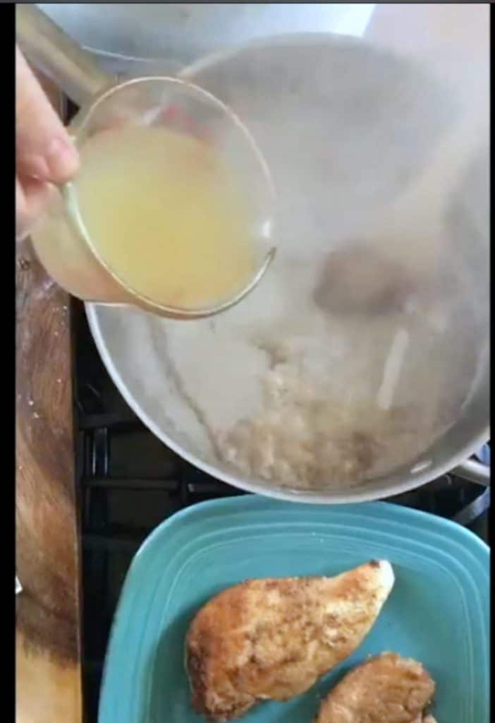 adding broth to a hot pan with steam