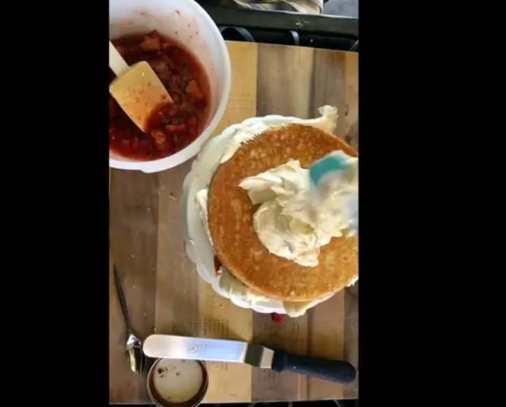 cutting board with cake stand and cake on top