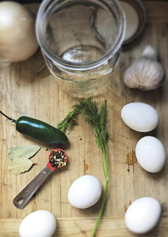 cutting board of ingredients needed for pickled eggs