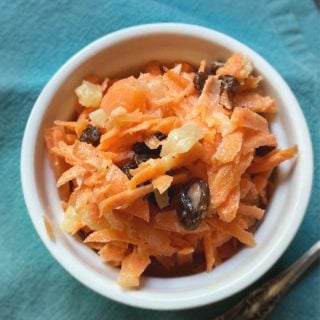 white bowl of carrot raisin salad
