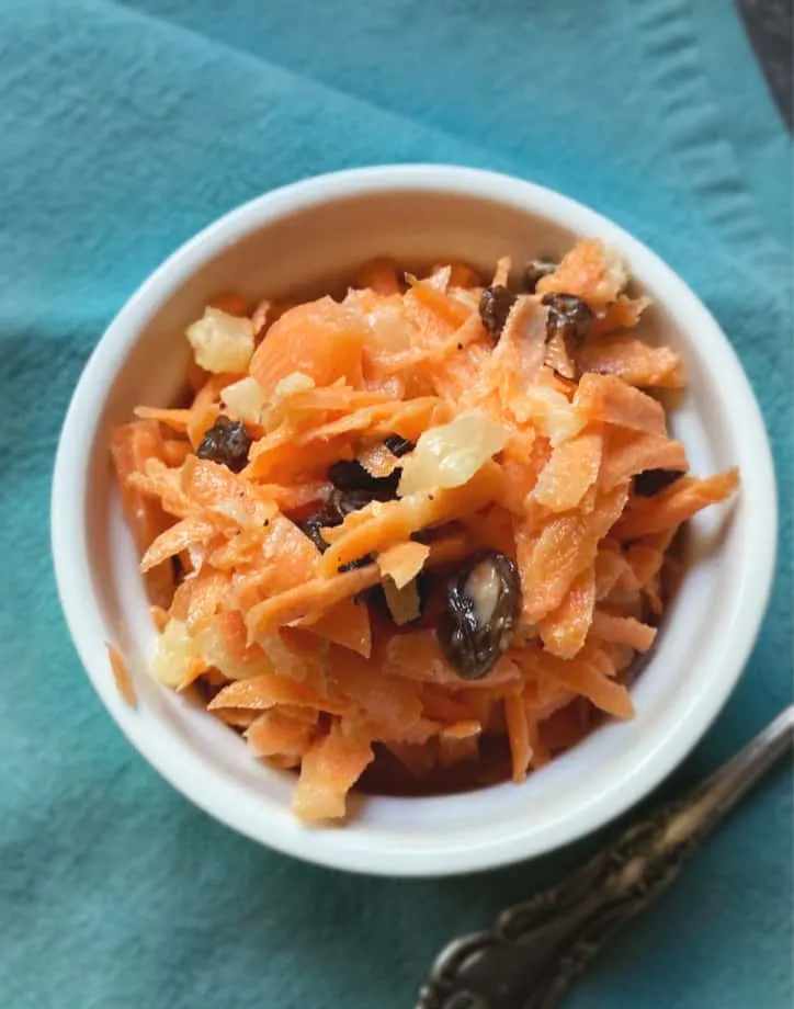 white bowl of carrot raisin salad