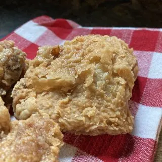 fried chicken thigh on checked napkin