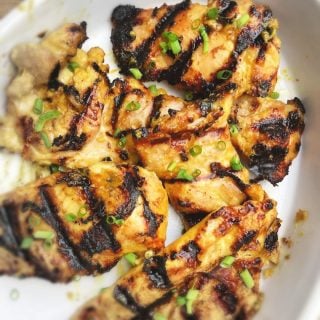white dish with pieces of grill marked chicken