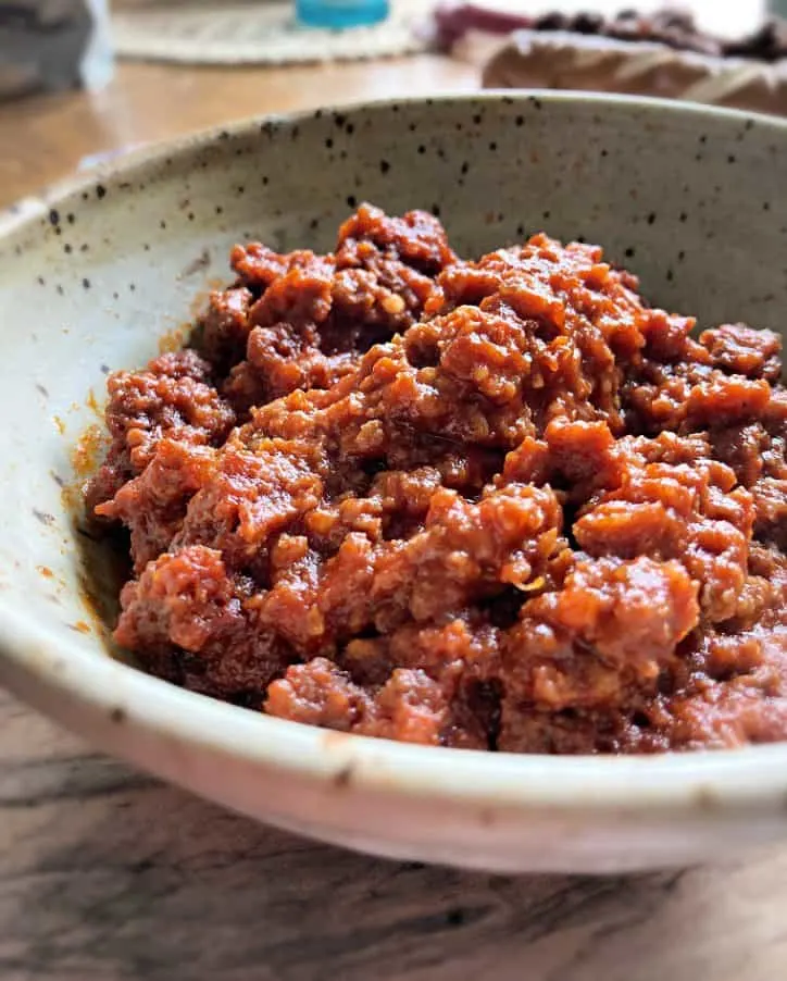 brown crock type bowl on wooden board filled with south carolina hot dog chili recipe